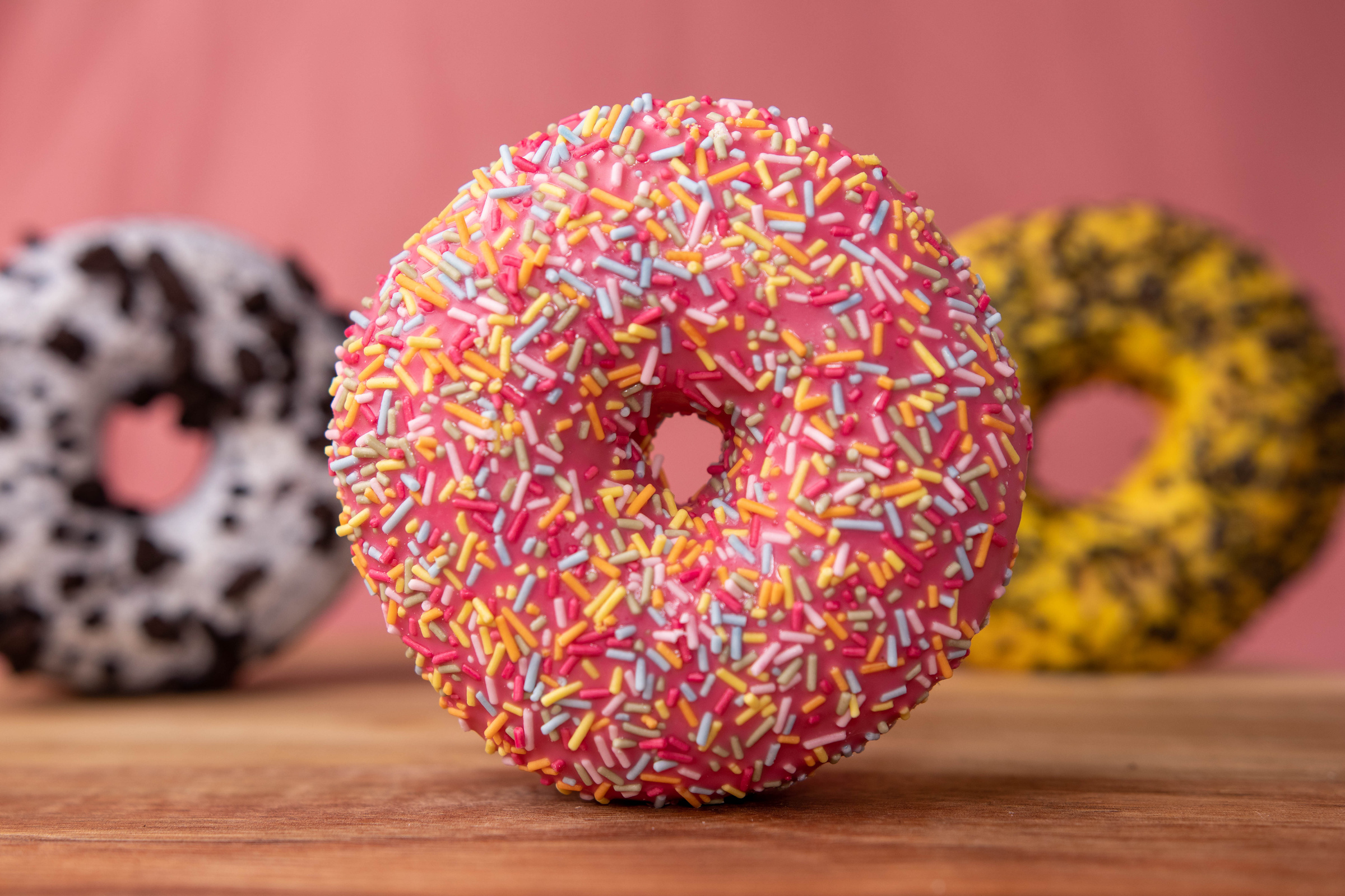 Doughnut With Sprinkles on Brown Wooden Table